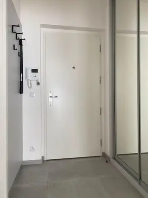 a white door in a room with a mirror at Quiet apartment near Prague centre in Prague