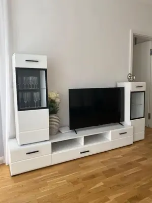 a white entertainment center with a flat screen tv at Quiet apartment near Prague centre in Prague