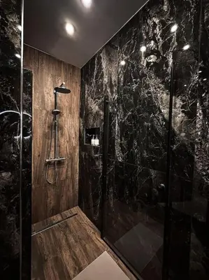 a bathroom with a shower with black marble walls at Château Étoile Loft - PRG Centre in Prague