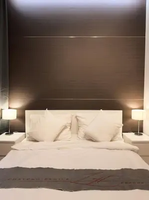 a bedroom with a large white bed with two lamps at Château Étoile Loft - PRG Centre in Prague