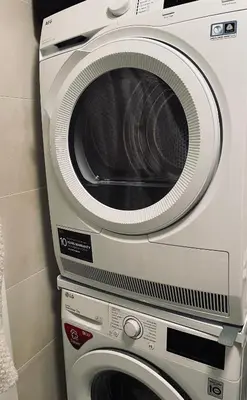 a dryer and a washing machine in a room at Cozy apartment, close to city center of beautiful Prague in Prague