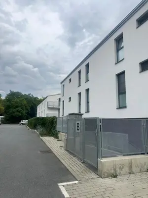 a white building with a fence next to a street at Cozy apartment, close to city center of beautiful Prague in Prague