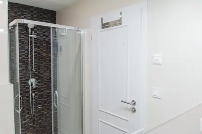 a shower with a glass door in a bathroom at Unique apartment by Wenceslas square in Prague