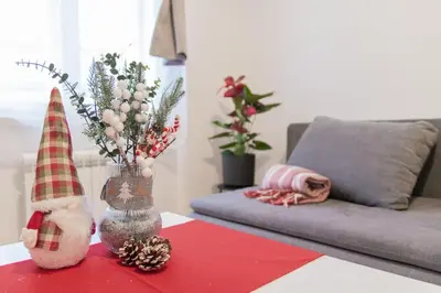 a living room with a vase with christmas decorations on a table at Unique apartment by Wenceslas square in Prague