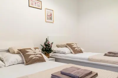 two beds in a room with a christmas tree at Unique apartment by Wenceslas square in Prague