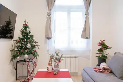 a living room with a christmas tree and a couch at Unique apartment by Wenceslas square in Prague