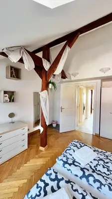 a bedroom with a large bed and wooden beams at Miru Loft Prague in Prague