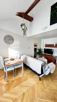a living room with a couch and a table at Miru Loft Prague in Prague