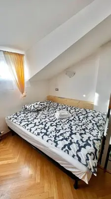 a bedroom with a bed with a black and white comforter at Miru Loft Prague in Prague