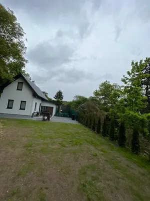 a white house with a fence and a yard at Wellness House Prague Pohádkový Ráj in Prague