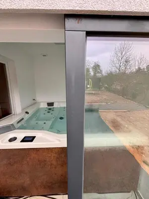 a view of a bath tub through a window at Wellness House Prague Pohádkový Ráj in Prague