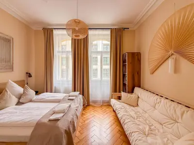 a living room with two beds and a couch at Radost Residence The Heart of Unique Living in Prague