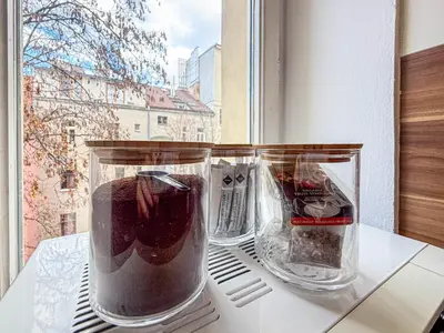 two vases sitting on a table in front of a window at Radost Residence The Heart of Unique Living in Prague