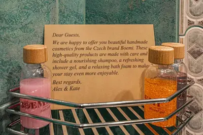 two bottles of essential oils on a rack with a sign at Radost Residence The Heart of Unique Living in Prague