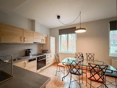 a kitchen with a table and chairs in a room at Radost Residence The Heart of Unique Living in Prague