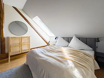a bedroom with a large bed with a large mirror at Radost Residence The Heart of Unique Living in Prague