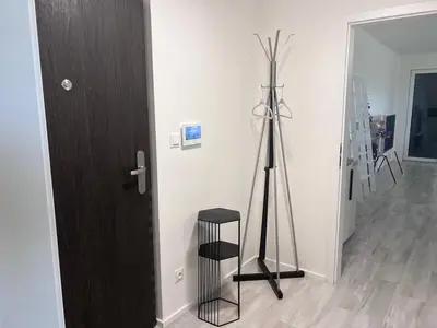 a room with a tripod next to a door at Modern apartment close to Tram and Airport, free parking in Prague