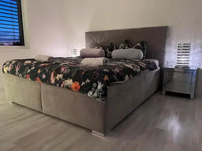 a large bed in a bedroom with at Modern apartment close to Tram and Airport, free parking in Prague