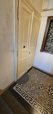 an empty room with a door and a tile floor at Historic Centre Apartments V in Prague