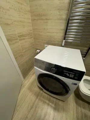a microwave sitting on the floor in a bathroom at Apartmán v nové rezidenci in Prague
