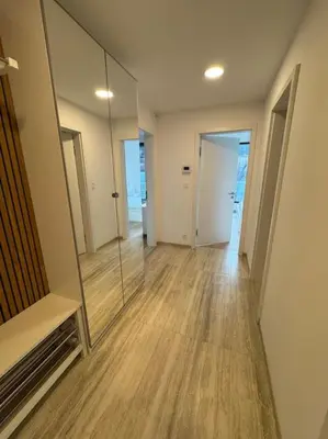 an empty room with a mirror and a hallway at Apartmán v nové rezidenci in Prague