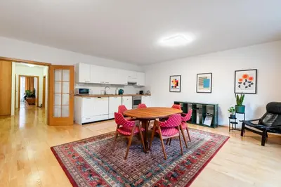 a kitchen and dining room with a table and chairs at Bliss Apartment in Prague
