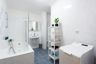 a bathroom with a tub and a toilet and a sink at Bliss Apartment in Prague