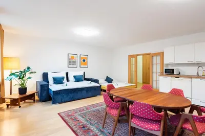 a living room with a table and a couch at Bliss Apartment in Prague