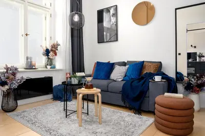 a living room with a blue couch and a table at Prague Days - Family-friendly Apartment with high speed Wi-Fi and Netflix in Prague