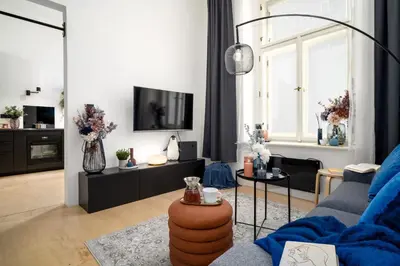 a living room with a couch and a tv at Prague Days - Family-friendly Apartment with high speed Wi-Fi and Netflix in Prague