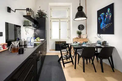 a kitchen with a table and chairs and a dining room at Prague Days - Family-friendly Apartment with high speed Wi-Fi and Netflix in Prague