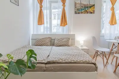 a bedroom with a bed and a table and chairs at Cozy Apartment by Wenceslas square in Prague