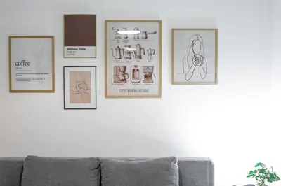 a living room with four framed pictures on a wall at Elegant Apartment in Wenceslas Square in Prague