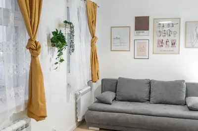 a living room with a couch and curtains at Elegant Apartment in Wenceslas Square in Prague