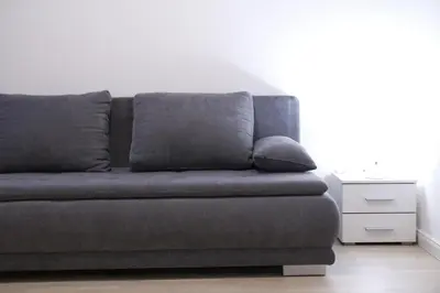 a couch with two pillows on it in a living room at Elegant Apartment in Wenceslas Square in Prague
