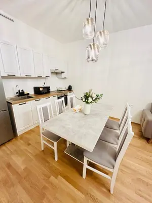 a kitchen and dining room with a table and chairs at New Luxury Apartmen at Andel Metro Station in Prague