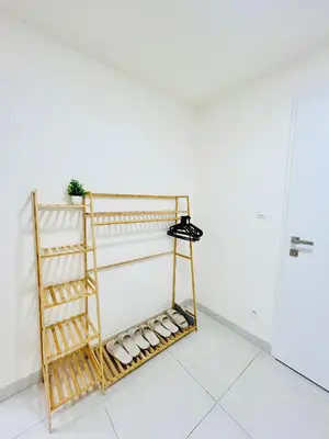 a rack of shoes in a white room at New Luxury Apartmen at Andel Metro Station in Prague