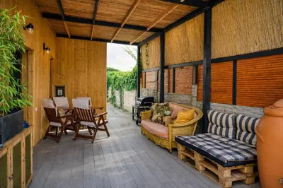 a screened in porch with a couch and chairs at House Big Win Mělník in Mlazice