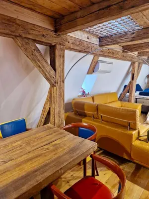 a room with a table and chairs and a couch at Large-Elegant-Central-terrace apartment in Prague