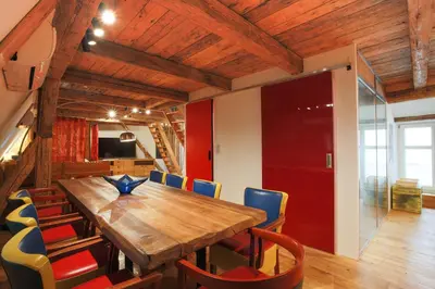a dining room with a wooden table and chairs at Large-Elegant-Central-terrace apartment in Prague