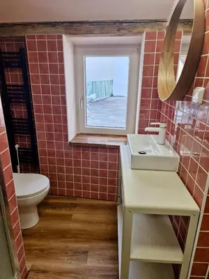 a bathroom with a toilet and a sink and a window at Large-Elegant-Central-terrace apartment in Prague