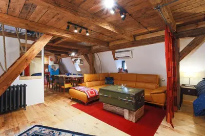 a living room with a couch and a table at Large-Elegant-Central-terrace apartment in Prague