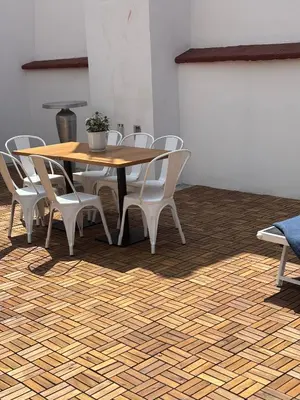 a wooden table with white chairs and a wooden floor at Large-Elegant-Central-terrace apartment in Prague
