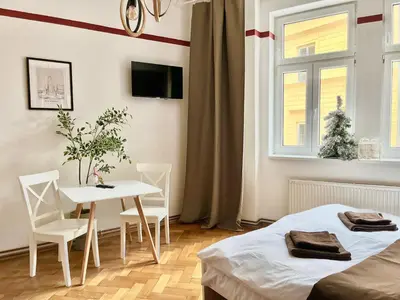 a bedroom with a bed and a table and chairs at Ruby Prague Apartment in Prague