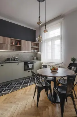 a kitchen with a table and chairs in a room at Francouzská Suites in Prague