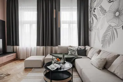a living room with a couch and a table at Francouzská Suites in Prague