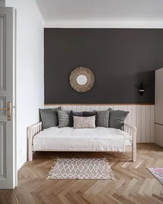 a bedroom with a bed with a mirror on the wall at Francouzská Suites in Prague