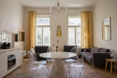 a living room with a table and a couch at Francouzská Suites in Prague
