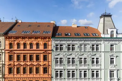 a group of buildings with a tower in the background at Hotel Ambiance in Prague
