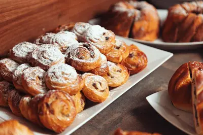 a bunch of pastries on plates on a table at Hotel Ambiance in Prague